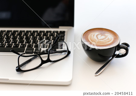 Laptop on Vintage Wooden desktop in modern office 20458411
