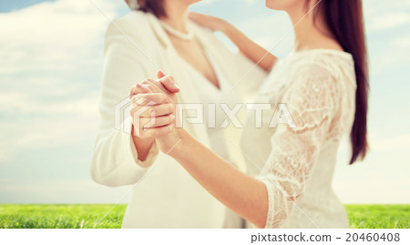 close up of happy married lesbian couple dancing 20460408