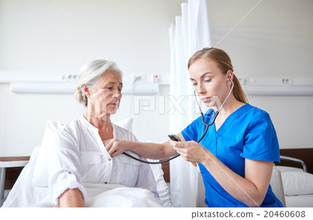 nurse with stethoscope and senior woman at clinic nurse with stethoscope and senior woman at clinic 20460608