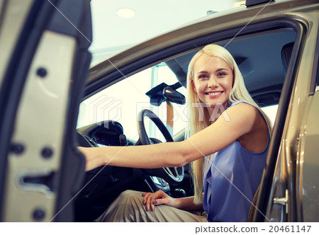 happy woman inside car in auto show or salon 20461147