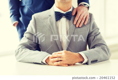 close up of male gay couple with wedding rings on 20461152