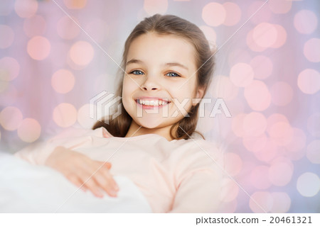 happy smiling girl lying awake in bed at home 20461321