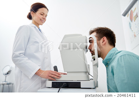 optician with tonometer and patient at eye clinic optician with tonometer and patient at eye clinic 20461411