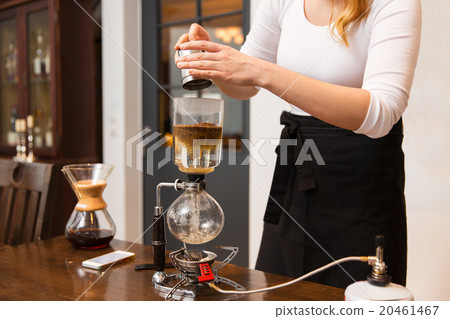 close up of woman with siphon coffee maker and pot 20461467