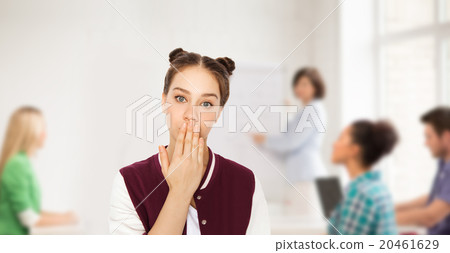 confused student girl covering her mouth by hand confused student girl covering her mouth by hand 20461629