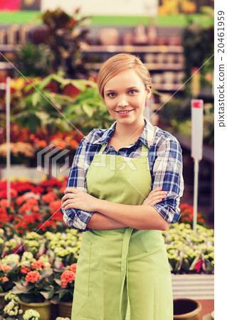 happy woman with flowers in greenhouse happy woman with flowers in greenhouse 20461959