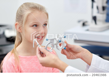 optician with trial frame and girl at clinic optician with trial frame and girl at clinic 20461986
