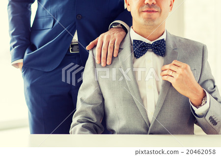 close up of male gay couple with wedding rings on 20462058