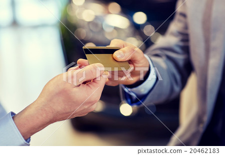 customer giving credit card to car dealer in salon customer giving credit card to car dealer in salon 20462183