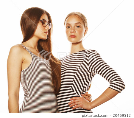two young workers isolated on white, same dresses two young workers isolated on white, same dresses 20469512