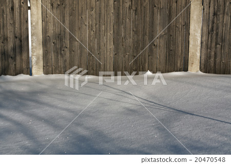 Old wooden fence in snow. 20470548