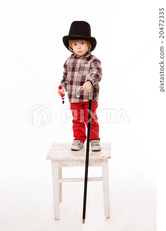 Beautiful baby in top hat on stool Beautiful baby in top hat on stool 20472335