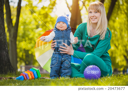 Happy mother and baby on the meadow 20473677