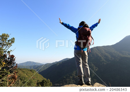 successful woman hiker open arms on mountain peak 20486343