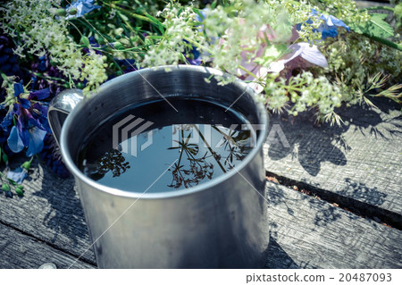 mug with the liquid metal on a wooden table mug with the liquid metal on a wooden table 20487093
