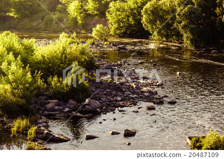 small river with rocky shores and trees small river with rocky shores and trees 20487109