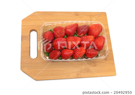 ripe strawberries on a cutting board on a white 20492950