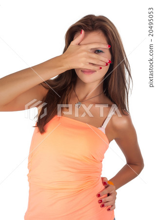 Young red-haired woman spots through fingers Young red-haired woman spots through fingers 20495053
