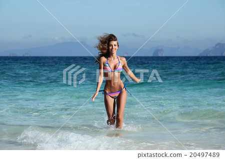 Woman run on beach Woman run on beach 20497489