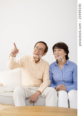 Senior couple looking far away by two people Senior couple looking far away by two people 20499190