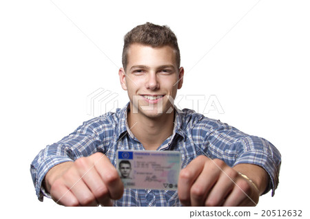 Young man showing off his driver license Young man showing off his driver license 20512632