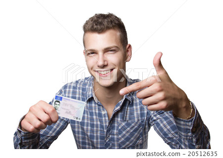 Young man showing off his driver license 20512635