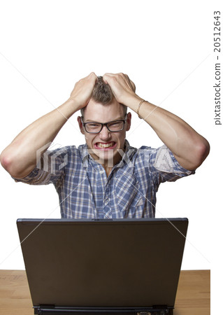 Aggressive boy sitting at the Computer 20512643