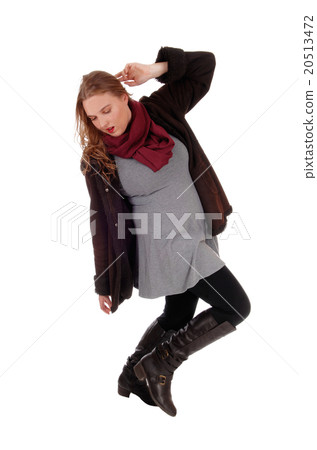 Lovely woman in winter coat dancing. 20513472