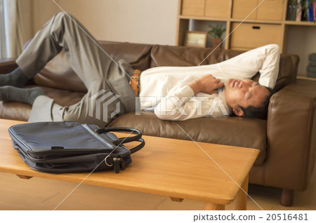A tired man in a sofa sleeps 20516481