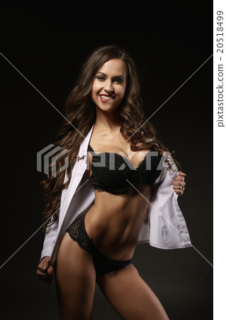 Sexy girl with a flirtatious smile in lingerie.   20518499