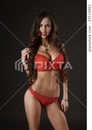 Sexy brunette girl standing in a flirtatious pose. 20519061