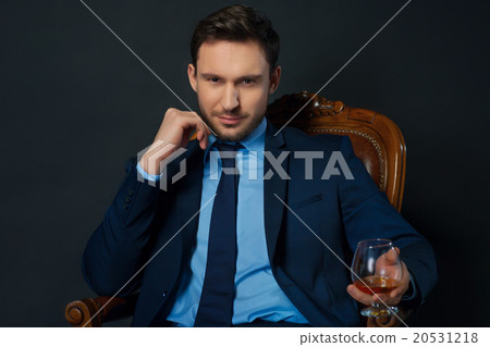 Handsome businessman drinking alcohol Handsome businessman drinking alcohol 20531218