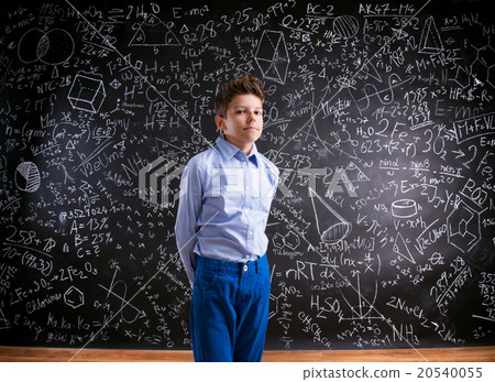 Boy against big blackboard with mathematical 20540055