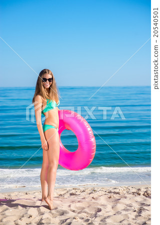 Girl with a rubber ring on the beach. Girl with a rubber ring on the beach. 20540501