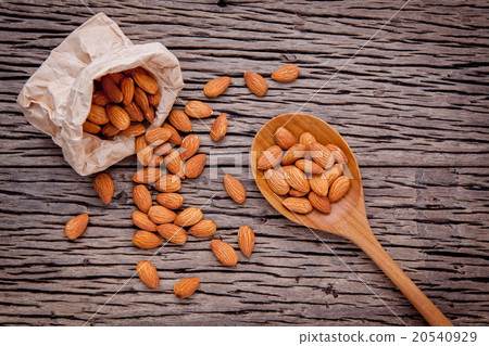 Almonds in brown paper bag and white bowl. Almonds in brown paper bag and white bowl. 20540929