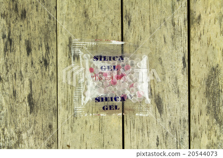 silica gel in plastic bag on wood plank silica gel in plastic bag on wood plank 20544073