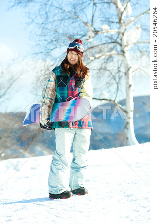 A woman enjoying snowboarding on the slopes 20546264