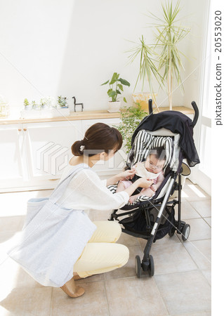 Baby and mother riding a stroller 20553020