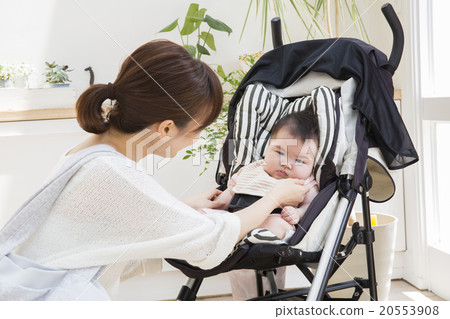 Baby and mother riding a stroller Baby and mother riding a stroller 20553908
