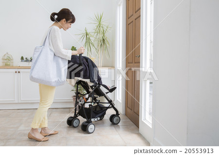 Baby and mother riding a stroller 20553913