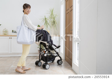 Baby and mother riding a stroller Baby and mother riding a stroller 20553914