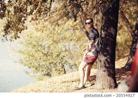 young man in autumn park young man in autumn park 20554927