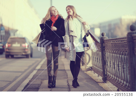 two cheerful blonde for a walk in the city two cheerful blonde for a walk in the city 20555138
