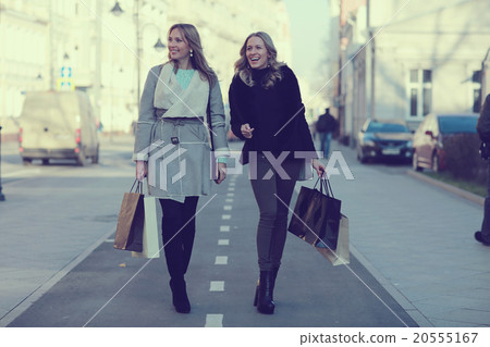 two cheerful blonde for a walk in the city two cheerful blonde for a walk in the city 20555167