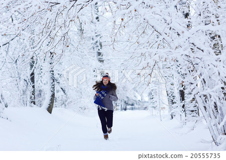 Girl running in winter park snow vacation Girl running in winter park snow vacation 20555735