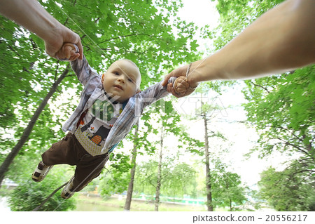 Dad playing with baby flying tosses summer 20556217