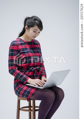 Woman sitting on chair Woman sitting on chair 20557629