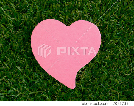 Pink heart-shaped notpad on the artificial grass Pink heart-shaped notpad on the artificial grass 20567331