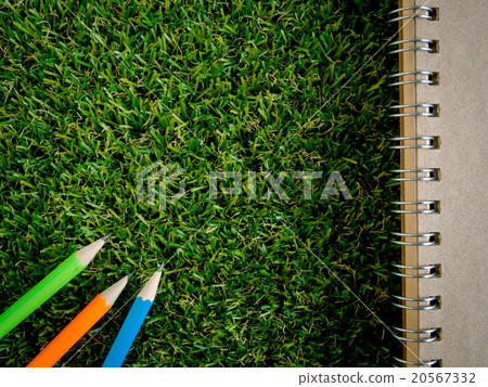 Book and colorful pencil on green artificial grass Book and colorful pencil on green artificial grass 20567332