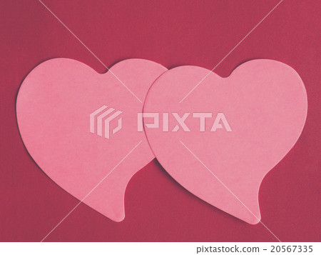 Two pink heart-shaped notepad on red leather Two pink heart-shaped notepad on red leather 20567335